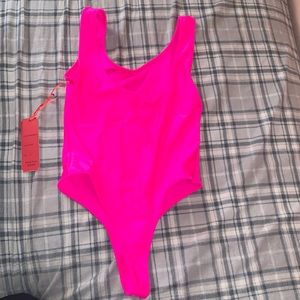 Fushia Body Suit. Size Medium. Never worn & w/tags